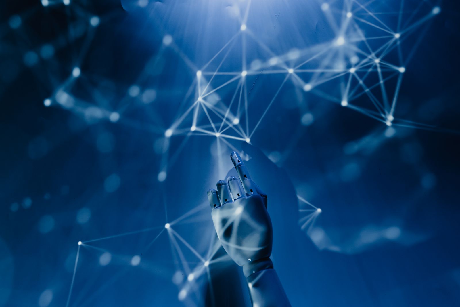 A robotic hand interacting with a glowing digital network