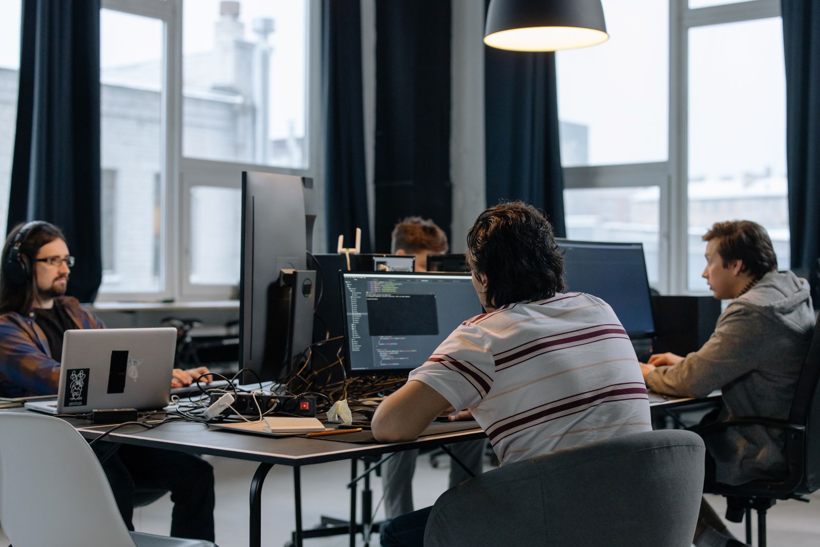 Software developers collaborating at their workstations